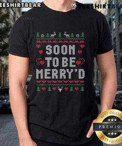 Engaged couple wearing matching 'Good Soon To Be Merry' ugly Christmas t-shirts, celebrating their love during the holiday season.
