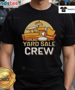 Good yard sale crew seller showcasing colorful T-shirts for sale at a vibrant community yard sale event.