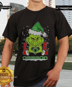 2024 Oregon Ducks Football Christmas T-Shirt featuring a Grinch and love heart design, perfect for holiday fans.