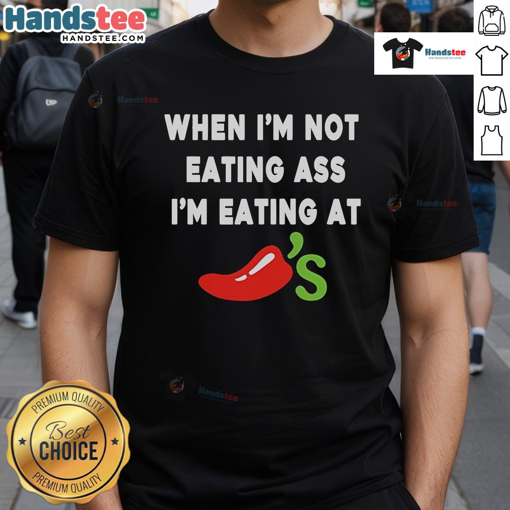 Official When I'M Not Eating Ass I'M Eating At Chili'S T Shirt Alt Text: Official When I'M Not Eating Ass I'M Eating At Chili'S T-Shirt featuring bold text and playful design for food enthusiasts.