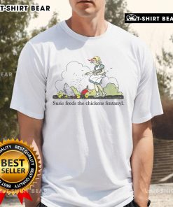 Pretty Susie feeds a chicken while wearing a 'Fentanyl T-Shirt', showcasing a humorous and quirky fashion statement.