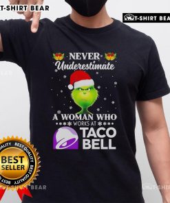 Alt Text: Top Grinch Christmas T-Shirt featuring 'Never Underestimate A Woman Who Works At Taco Bell' design.