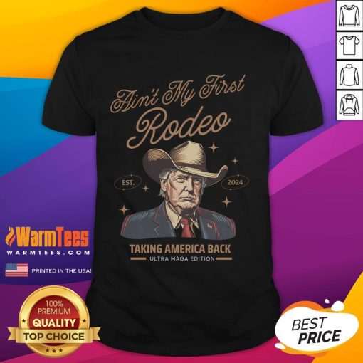 Alt Text: Awesome Ain'T My First Rodeo Trump Cowboy T-Shirt showcasing patriotic design, perfect for Trump supporters.