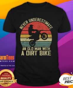 Alt Text: Vintage sunset T-shirt featuring the phrase Never Underestimate An Old Man With A Dirt Bike. Perfect for bike enthusiasts.