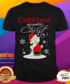Alt Text: Cute Christmas Begins With Christ T-Shirt featuring Snoopy in a festive holiday costume design for Xmas celebrations.