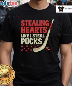 Alt Text: Cute hockey player design t-shirt with Stealing Hearts Like I Steal Pucks slogan, perfect for hockey fans.