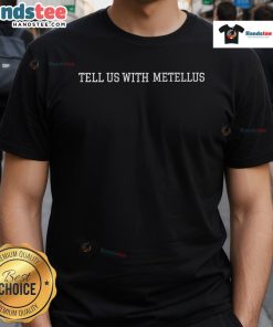 Good Joshua Metellus wearing a 'Tell Us With Metellus' t-shirt, showcasing style and personality in a casual setting.