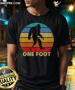 Vintage sunset t-shirt featuring Bigfoot with one foot prosthetic, celebrating amputated disability in a fun design.