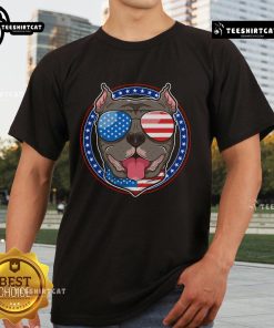 Happy Pitbull dog dad and mom wearing American flag t-shirt, showcasing love for Pit Bull dogs and patriotism.