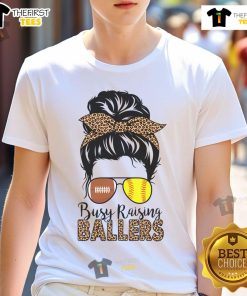 Softball and football mom wearing a messy bun t-shirt that says 'Nice Busy Raising Ballers' in vibrant colors.