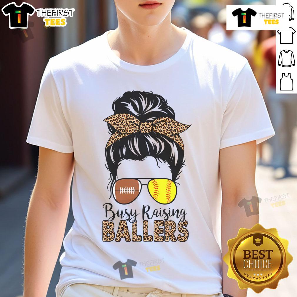 Nice Busy Raising Ballers Softball And Football Mom Messy Bun T Shirt Softball and football mom wearing a messy bun t-shirt that says 'Nice Busy Raising Ballers' in vibrant colors.