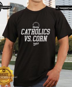 Alt Text: Official Rivalry Catholics Vs Corn Triple T-Shirt featuring bold graphics and vibrant colors for fans of both teams.