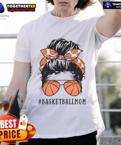 Pretty basketball mom in a messy bun wearing sunshades and a proud mama basketball t-shirt, cheering on her child.