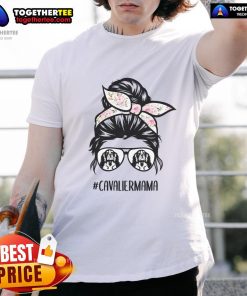 Top Cavalier King Charles Spaniel mom in messy bun, wearing glasses and a T-shirt, showcasing her love for dogs.