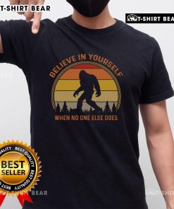 Vintage sunset t-shirt featuring a Sasquatch Big Foot graphic with 'Believe In Yourself' slogan for outdoor enthusiasts.