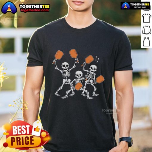 Top spooky skeletons playing pickleball on a Halloween-themed T-shirt design for festive sports lovers.