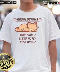 Cute cat graphic on a t-shirt with the phrase 'Sleep More, Nap More' promoting relaxation and comfort.
