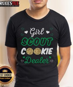 Adorable girl in a Girl Scout Cookie dealer T-shirt, showcasing her love for cookies and Scout spirit in a sunny outdoor setting.