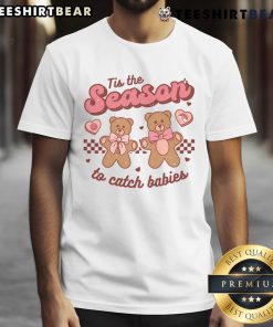 Alt Text: Cute 'Tis The Season To Catch Babies' T-Shirt featuring festive design, perfect for celebrating the holiday spirit.