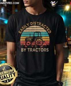 Alt Text: Vintage sunset T-shirt featuring a funny design about being easily distracted by tractors while farming.