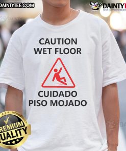 Funny wet floor sign graphic on a slippery Halloween t-shirt, perfect for spooky season and playful fashion.