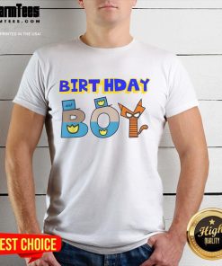 Happy birthday boy dog wearing a family party T-shirt, celebrating with balloons and cake at a festive gathering.