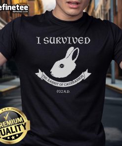 Official I Survived The Rabbit Of Caerbannog 932AD T-Shirt featuring a unique graphic design and bold lettering.