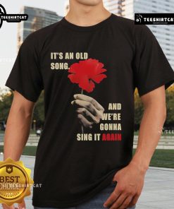 Official Hadestown 'It's An Old Song And We're Gonna Sing It Again' T-Shirt featuring vibrant design and lyrics.