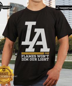 Official La Dream Flames Won't Dim Our Light T-Shirt featuring vibrant flame design and empowering message.