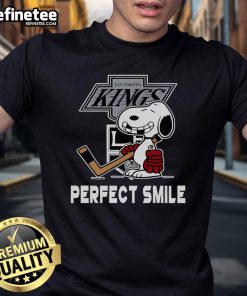 Alt Text: Official NHL Los Angeles Kings Snoopy Perfect Smile T-Shirt featuring Peanuts Movie design for hockey fans.