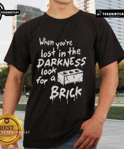 Official 'When You're Lost In The Darkness Look For A Brick' T-Shirt featuring a bold graphic design and stylish fit.