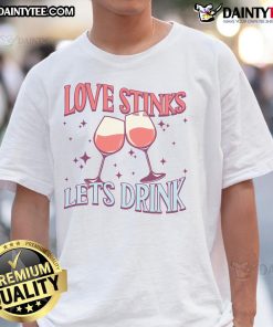 Couple wearing 'Pretty Love Stinks Let's Drink' Valentine's Day T-shirt, showcasing playful love-themed design.