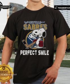 Alt Text: Buffalo Sabres Snoopy Perfect Smile T-Shirt featuring The Peanuts Movie character, ideal for hockey fans.