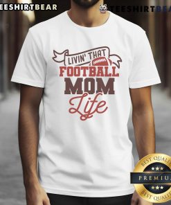 Alt Text: Funny Livin' That Football Mom Life T-Shirt featuring playful football graphics, perfect for proud football moms.