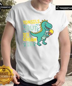 Child wearing a Dino T-shirt enjoying ice cream after tonsil removal, showcasing a fun and cheerful recovery moment.