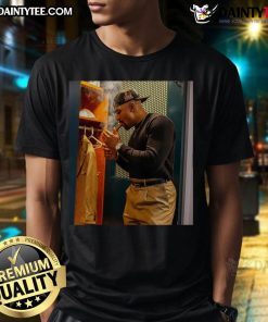 Hot Jalen Hurts celebrates with a cigar in a stylish t-shirt, showcasing his winning spirit and confidence.