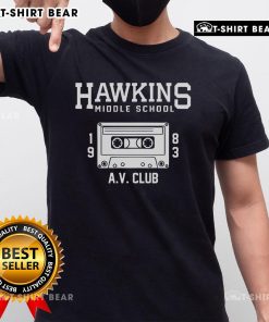 Alt Text: Official Hawkins Middle School AV Club T-Shirt featuring the iconic logo and design in vibrant colors.