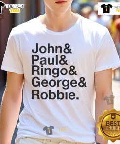Robbie Williams wears a John Paul Ringo George Robbie 2025 T-Shirt at an event, showcasing his unique style and music legacy.