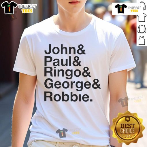 Robbie Williams wears a John Paul Ringo George Robbie 2025 T-Shirt at an event, showcasing his unique style and music legacy.