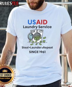 Official USAID Laundry Service T-Shirt featuring 'Laundering Money Since 1961' slogan, promoting USAID branding and humor.