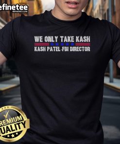 Alt Text: Official We Only Take Kash American Flag FBI Director T-Shirt featuring patriotic design and bold text.