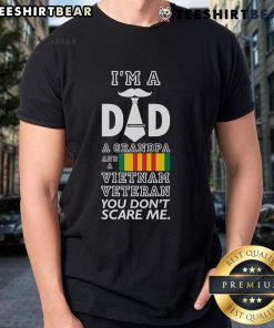 Alt Text: Top I'M A Dad Grandpa And A Vietnam Veteran You Don'T Scare Me T-Shirt design featuring bold text and patriotic colors.