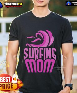 Surfing mom wearing a fun 'Top Surfing Mom' T-shirt, showcasing her love for surfing and motherhood on the beach.