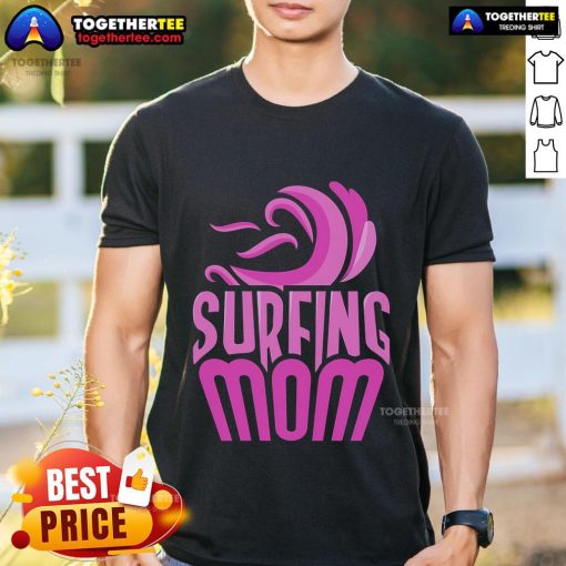 Surfing mom wearing a fun 'Top Surfing Mom' T-shirt, showcasing her love for surfing and motherhood on the beach.