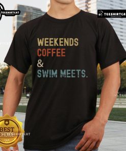 Swimmer mom wearing a 'Top Weekends Coffee Swim Meets' T-shirt at a swim meet, showcasing her love for swimming.