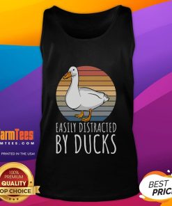 Adorable duck wearing a tank top, easily distracted by other ducks in a serene pond setting.