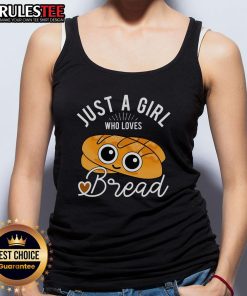 Cute girl wearing a 'Just a Girl Who Loves Bread' tank top while baking with a breadmaker in a cozy kitchen.