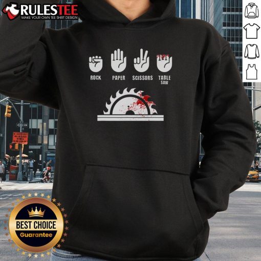 Funny carpenter playing rock-paper-scissors with a table saw, wearing a humorous hoodie for woodworking enthusiasts.