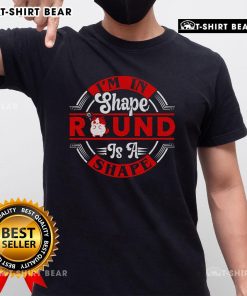 Funny cat wearing 'I'm In Shape Round Is A Shape' t-shirt, perfect for cat lovers and humor enthusiasts.