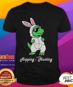 Alt Text: Funny Dino in a cute Easter Bunny rabbit costume on a colorful T-shirt, perfect for festive celebrations and dino lovers.
